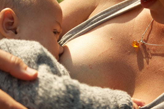 Mother holding breastfeeding baby